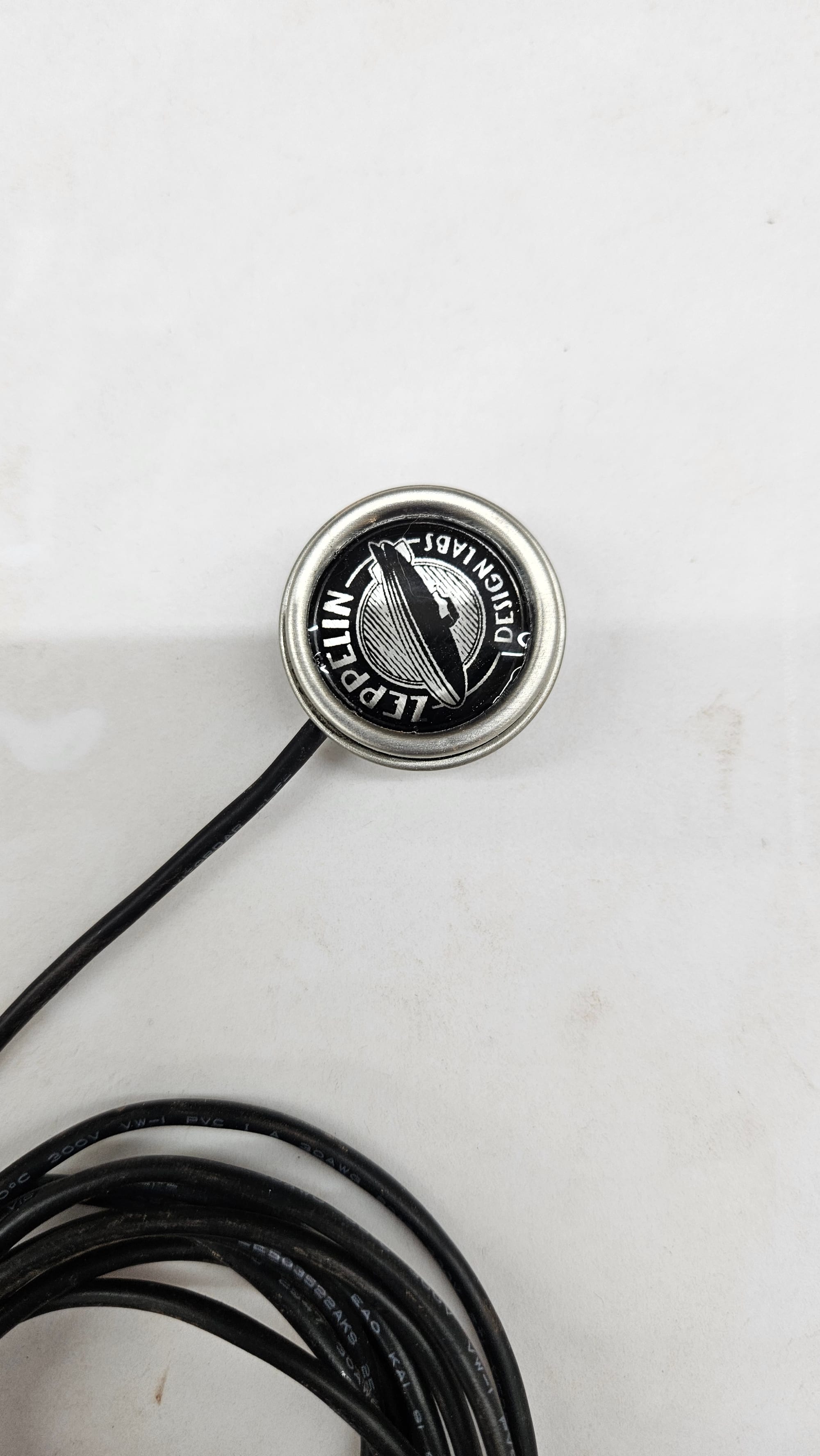 Close-up of Cortado Xe piezo sensor in steel housing