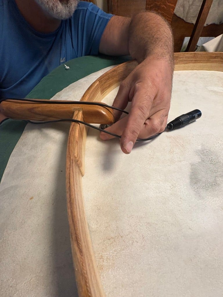 Close-up of the Cortado Xe mounted just above the drum's handle, held in place with light pressure from a piece of foam